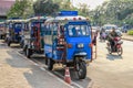 A popular public taxi transport in Laos - tuk-tuk - a motorcycle with a cab for passengers Royalty Free Stock Photo