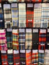 Iconic tartan scarves on sale in Scotland capital Edinburgh with many patterns Royalty Free Stock Photo