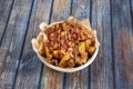 Popular recipe for potato wedges fried in their own skin with lots of fried bacon chopped into tacos and plenty