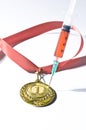 Popular red steroid in syringe as a doping stabs a gold medal on a white background