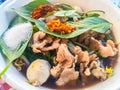 Popular street food in Thailand, Spicy pork noodle that consisted of pork ball, pork meat, basil or thyme, bean sprouts, morning Royalty Free Stock Photo