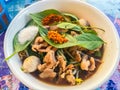 Popular street food in Thailand, Spicy pork noodle that consisted of pork ball, pork meat, basil or thyme, bean sprouts, morning Royalty Free Stock Photo