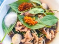 Popular street food in Thailand, Spicy pork noodle that consisted of pork ball, pork meat, basil or thyme, bean sprouts, morning Royalty Free Stock Photo