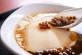 Popular Taiwan gourmet - Dessert of tapioca pearl ball bubble mixed bean curd tofu pudding douhua, dou hua in white bowl,