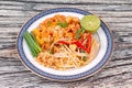 Popular Thai fried noodle call Pad Tai on Thai-pattern dish. Royalty Free Stock Photo