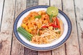 Popular Thai fried noodle call Pad Tai on Thai-pattern dish. Royalty Free Stock Photo