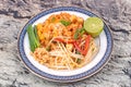 Popular Thai fried noodle call Pad Tai on Thai-pattern dish.