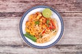 Popular Thai fried noodle call Pad Tai on Thai-pattern dish. Royalty Free Stock Photo