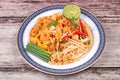 Popular Thai fried noodle call Pad Tai on Thai-pattern dish. Royalty Free Stock Photo