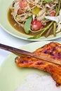 Popular Thailand food green papaya salad spicy with chicken grill