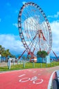 Popular tourist places in the city of Batumi. Ferris wheel on the embankment. Dedicated road for cyclists