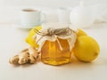 Popular ways to treat a cold - a jar of honey, ginger, lemons on