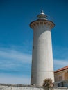 Popular white lighthouse with a concrete tower and an active light, Bibione