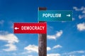 Populism versus Democracy - Road sign with two options.