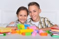 Brother and sister playing with colorful plastic blocks together Royalty Free Stock Photo