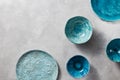 Porcelain blue bowls and plates on a gray marble table. Multi-colored ceramic vintage handmade dishes Royalty Free Stock Photo