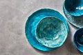 Porcelain blue bowls and plates on a gray table . Colorful ceramic vintage handmade dishes. Flat lay Royalty Free Stock Photo