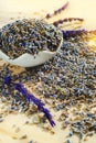 Porcelain bowl with dried lavender blossoms on wooden table in sunlight. Calming beverage Royalty Free Stock Photo