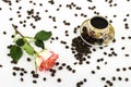 Porcelain coffee cup with rose flower and coffee beans Royalty Free Stock Photo