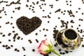 Porcelain coffee cup with rose flower and coffee beans heart Royalty Free Stock Photo