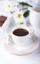 Porcelain cup of black coffee and chrysanthemums flowers on a white background Royalty Free Stock Photo