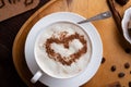 Porcelain cup of coffee with ice cream and cinnamon heart served at black wooden table. life style concept. flat lay