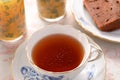 Porcelain cup filled with tea. Chocolate pound cake Royalty Free Stock Photo