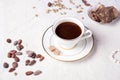 Porcelain cup of mocca coffee with natural chocolate, cocao beans, green coffe beans and neck beads around white provence