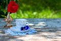 Porcelain cup of tea and beautiful spring flowers in vase on a wooden table in the garden. Summer party. Royalty Free Stock Photo