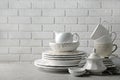 Porcelain dishware on table and white wall background Royalty Free Stock Photo