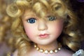 Porcelain Doll Face with Blond Curly Hair Royalty Free Stock Photo