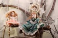 Porcelain dolls on swings photo. Royalty Free Stock Photo