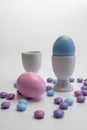 Porcelain Egg Cups with pink and blue Easter egg. Royalty Free Stock Photo