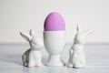 Porcelain Egg Cups with pink Easter egg and porcelain Easter bunnies Royalty Free Stock Photo