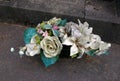 Porcelain flowers on tomb stones in graveyard.