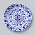 Porcelain plate with blue round ornament in ethnic style. Decorative pattern in the style of national flower painting. Ornate