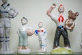 Assortment of rare porcelain figurines on glass shelf Royalty Free Stock Photo