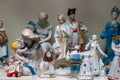 Assortment of rare porcelain figurines on glass shelf Royalty Free Stock Photo