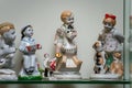 Assortment of rare porcelain figurines on glass shelf Royalty Free Stock Photo