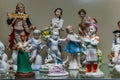 Assortment of rare porcelain figurines on glass shelf Royalty Free Stock Photo