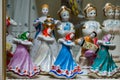 Assortment of rare porcelain figurines on glass shelf Royalty Free Stock Photo