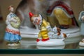 Assortment of rare porcelain figurines on glass shelf Royalty Free Stock Photo