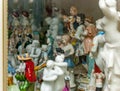 Assortment of rare porcelain figurines on glass shelf Royalty Free Stock Photo