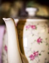 Porcelain Spout aginst a blurry flower coffee or tea pot. Abstract vintage concept