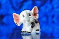 Porcelain statuette, porcelain statuette of the elephant on a blue background Royalty Free Stock Photo