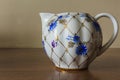 Porcelain sugar bowl, cup, milk, dish with golden pattern and blue flowers. Royalty Free Stock Photo