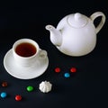 Porcelain teapot and tea cup on black background Royalty Free Stock Photo