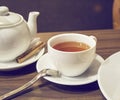Porcelain teapot, teacup, spoon and canella Royalty Free Stock Photo