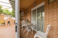 Porch with aluminum enclosure next to a tiled patio of a single-family home