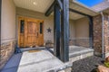 Porch and brown front door of home on a sunny day Royalty Free Stock Photo